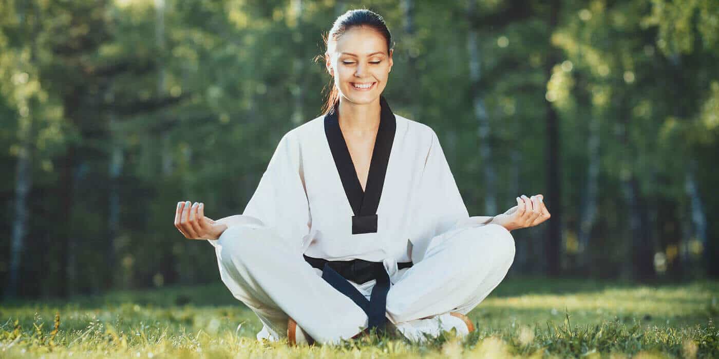 Martial Arts Lessons for Adults in Arvada CO - Happy Woman Meditated Sitting Background
